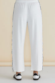 A model wearing the Evelyn Wide Leg Jogger in colour White (White), from the back