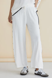 A model wearing the Evelyn Wide Leg Jogger in colour White (White), from the front, cropped image