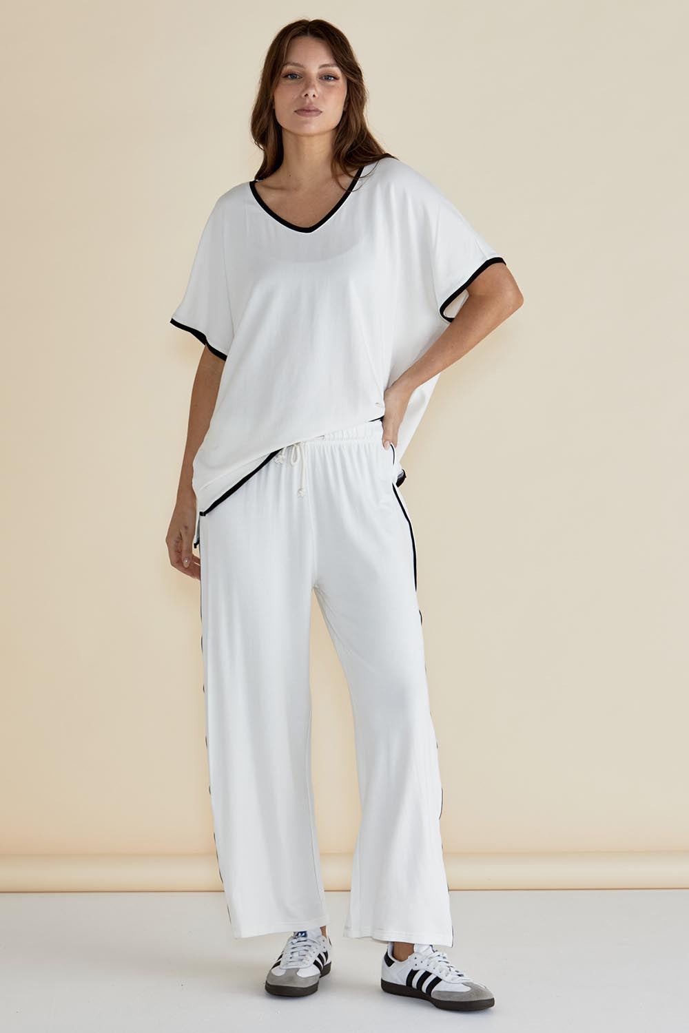 A model wearing the Evelyn Wide Leg Jogger in colour White (White), from the front, showing the whole outfit
