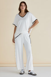A model wearing the Evelyn Wide Leg Jogger in colour White (White), from the front, showing the whole outfit