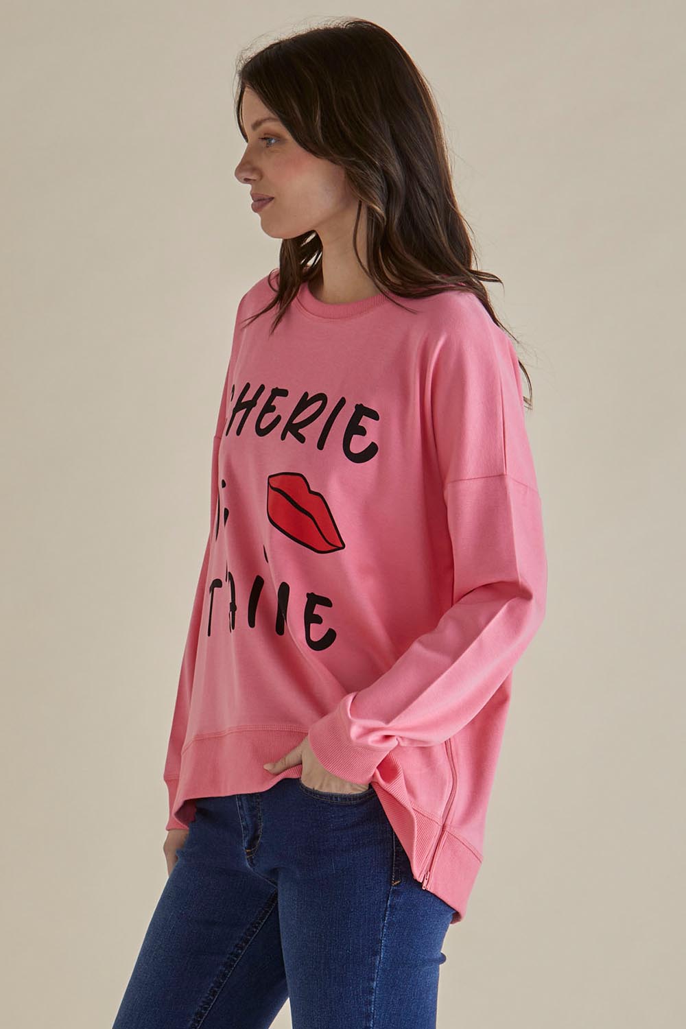 A model wearing the Sonya Cotton Blend Sweat in colour Loveprint (Pink), from the front, cropped image