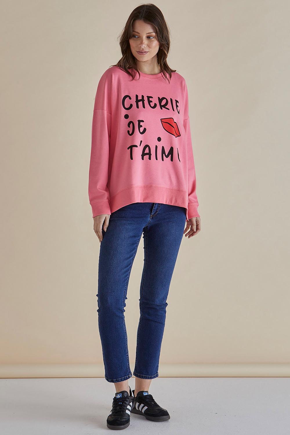 A model wearing the Sonya Cotton Blend Sweat in colour Loveprint (Pink), from the front, showing the whole outfit