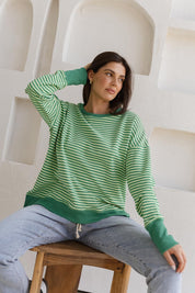 A model wearing the Cove Cotton Blend Sweat Jumper in colour Green (Green), from the front, showing the whole outfit
