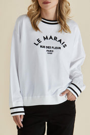A model wearing the Marais Cotton Sweat in colour White (White), from the front, cropped image