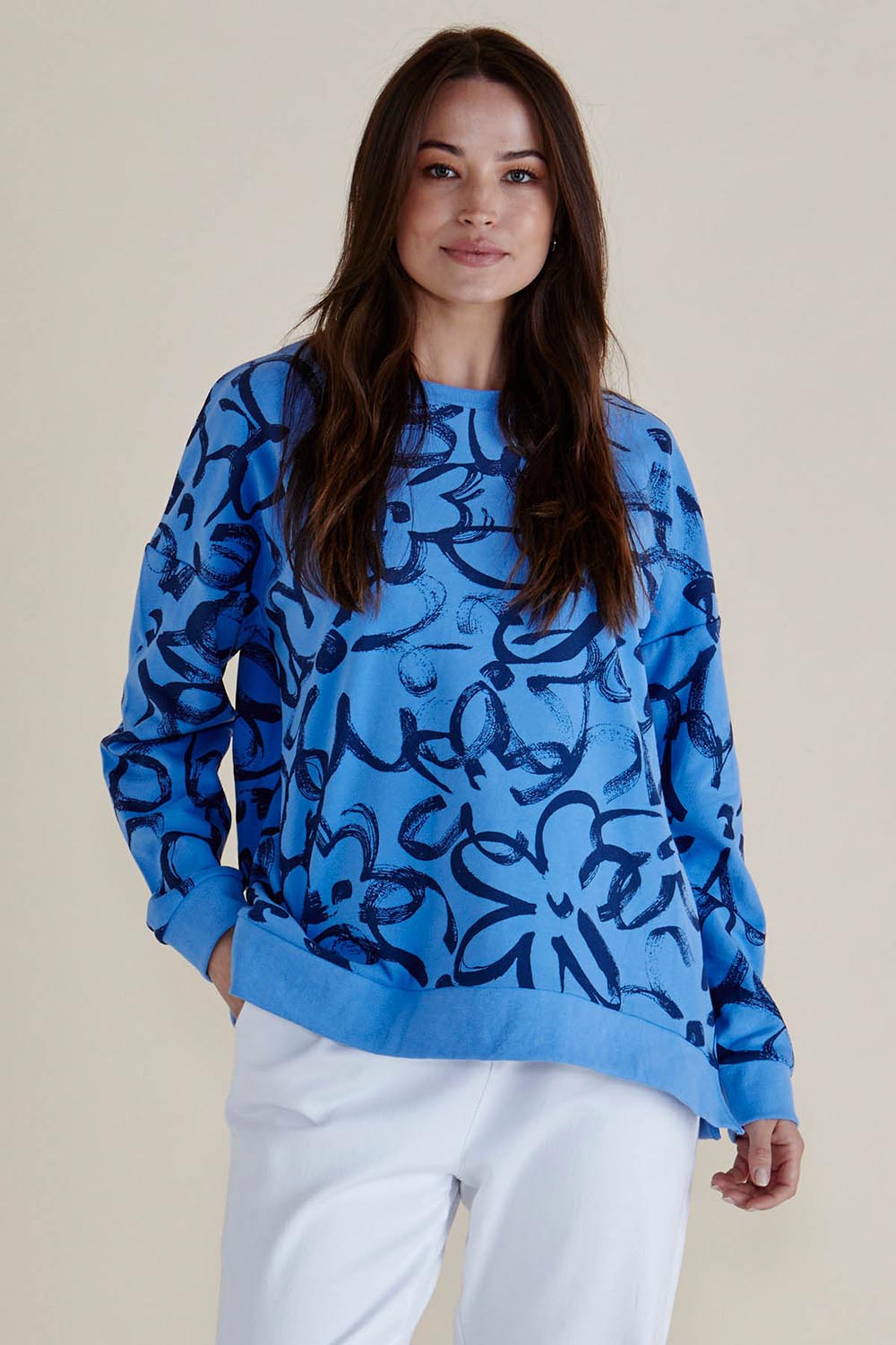 A model wearing the Palma Sweat in colour Bluefloral (Blue), from the front, cropped image