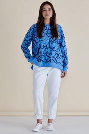 A model wearing the Palma Sweat in colour Bluefloral (Blue), from the front, showing the whole outfit