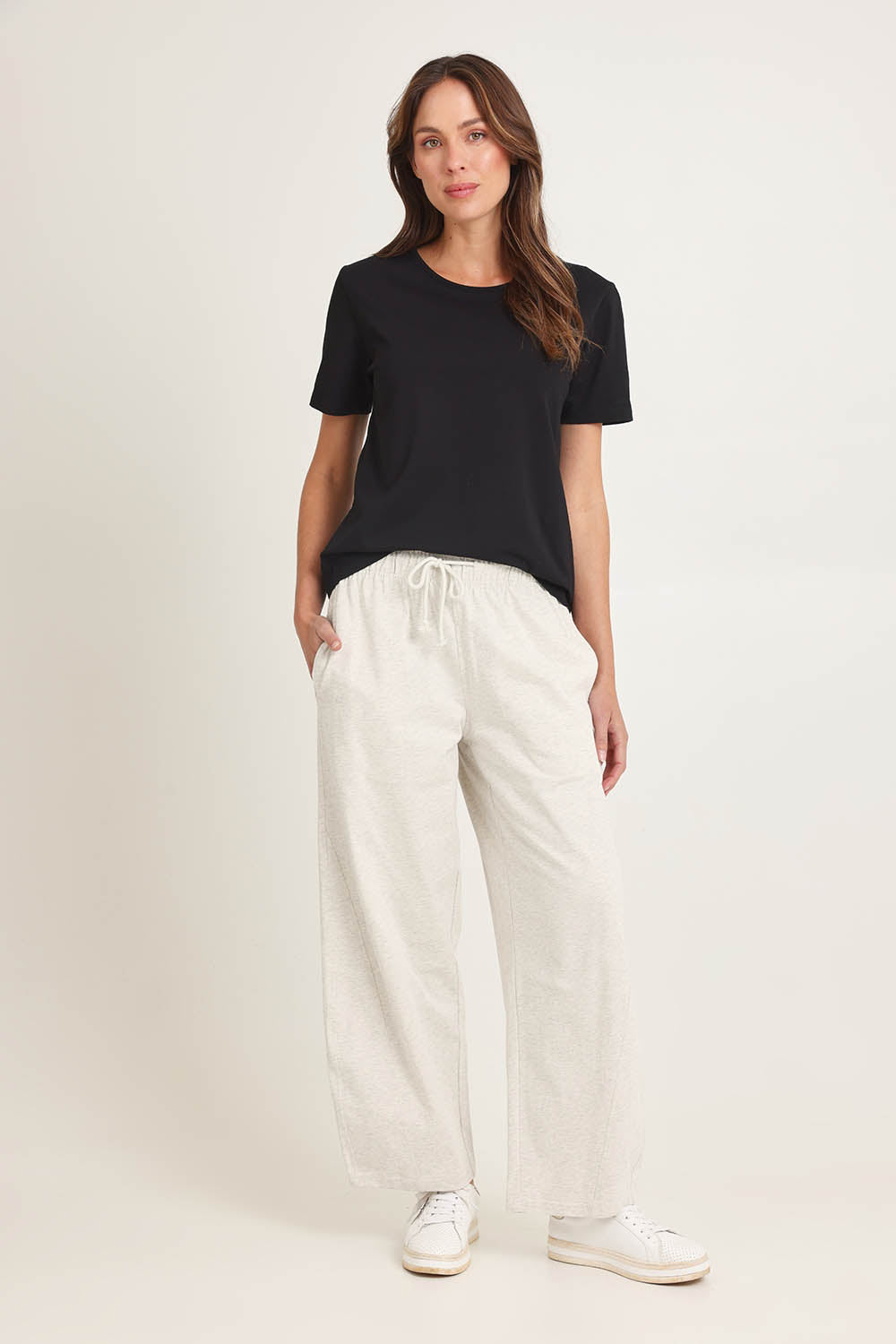 Model Madeline wearing size 10 of the Barrel Leg Cotton Sweatpant in colour Greymarle (Grey), from the front, showing the whole outfit