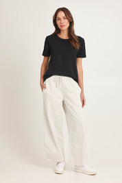 Model Madeline wearing size 10 of the Barrel Leg Cotton Sweatpant in colour Greymarle (Grey), from the front, showing the whole outfit