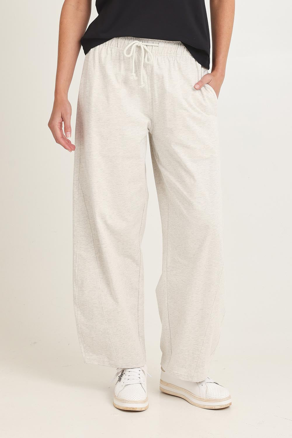 Model Madeline wearing size 8 of the Barrel Leg Cotton Sweatpant in colour Greymarle (Grey), from the front, cropped image