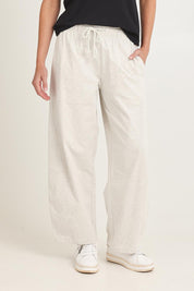 Model Madeline wearing size 8 of the Barrel Leg Cotton Sweatpant in colour Greymarle (Grey), from the front, cropped image
