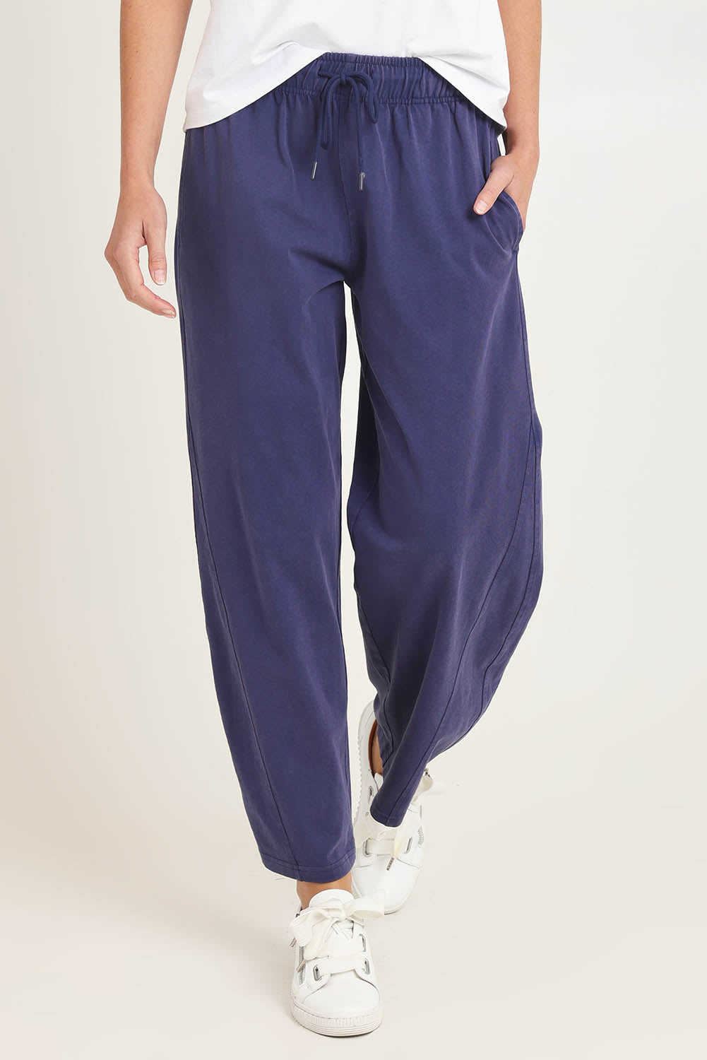 Model Madeline wearing size 10 of the Barrel Leg Cotton Sweatpant in colour Navy (Blue), from the front, cropped image