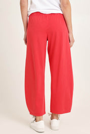 Model Madeline wearing size 10 of the Barrel Leg Cotton Sweatpant in colour Red (Red), from the back