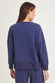 Model Madeline wearing size 10 of the Iris Cotton Sweatshirt in colour Navy (Blue), from the back