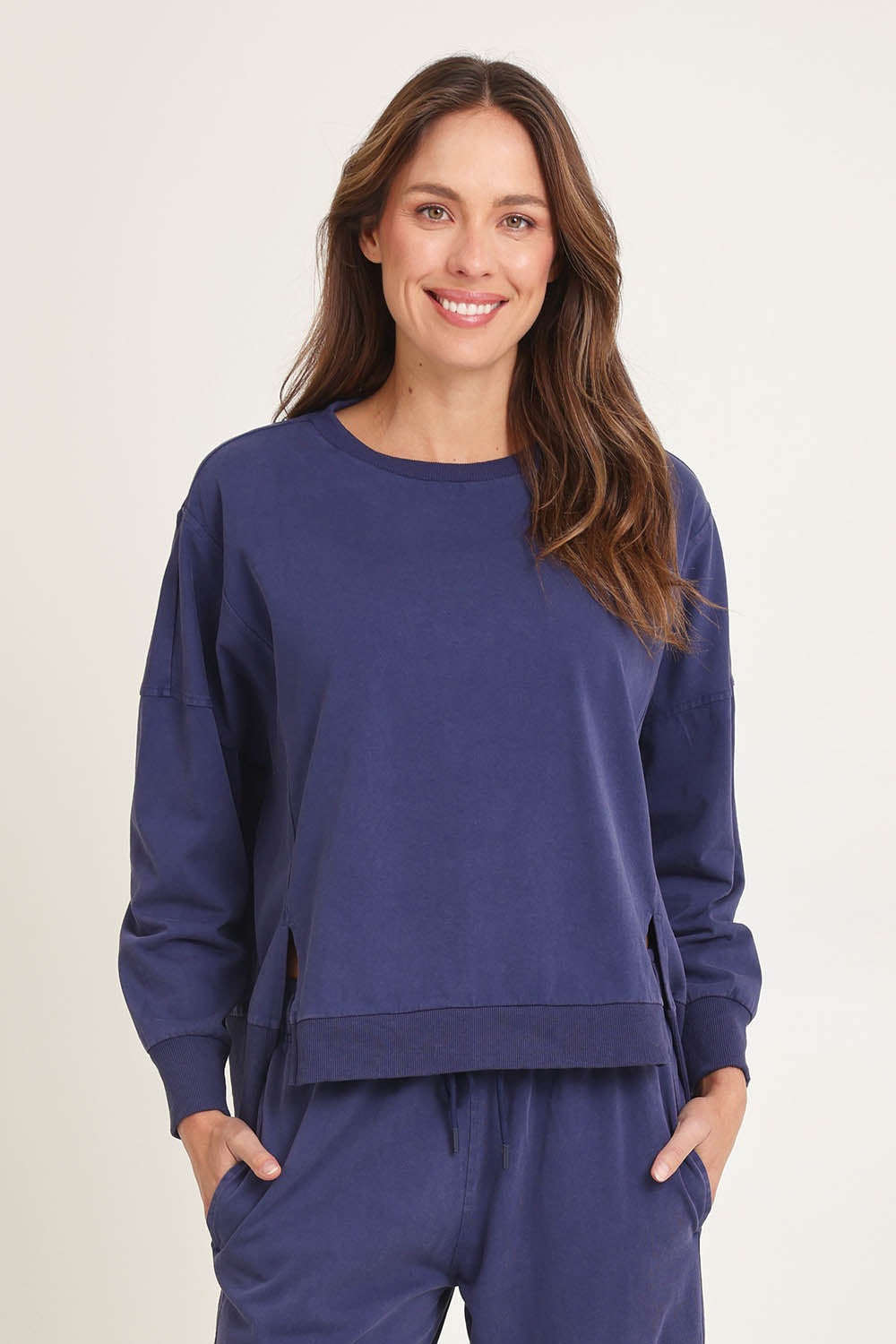 Model Madeline wearing size 10 of the Iris Cotton Sweatshirt in colour Navy (Blue), from the front, cropped image