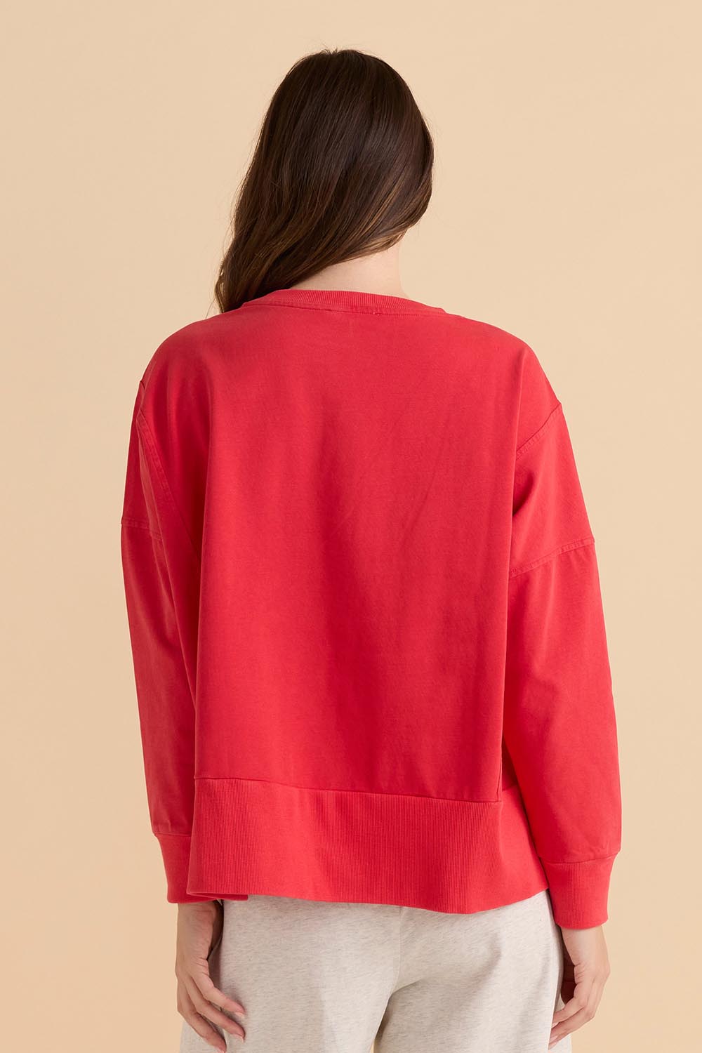 A model wearing the Iris Cotton Sweatshirt in colour Red (Red), from the back