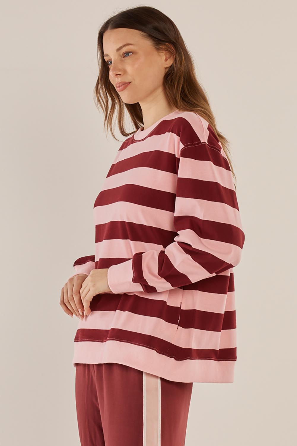 A model wearing the Stazie Sweatshirt in colour Pinkred (Pink), from the front, cropped image