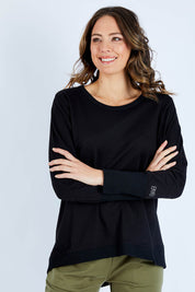 Model Madeline wearing size 10 of the Dolly Sweat in colour Black (Black), from the front, cropped image
