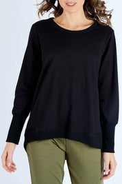 Model Madeline wearing size 10 of the Dolly Sweat in colour Black (Black), from the front, cropped image