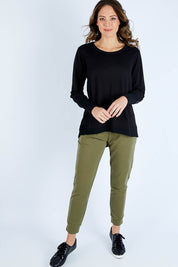 Model Madeline wearing size 10 of the Dolly Sweat in colour Black (Black), from the front, showing the whole outfit