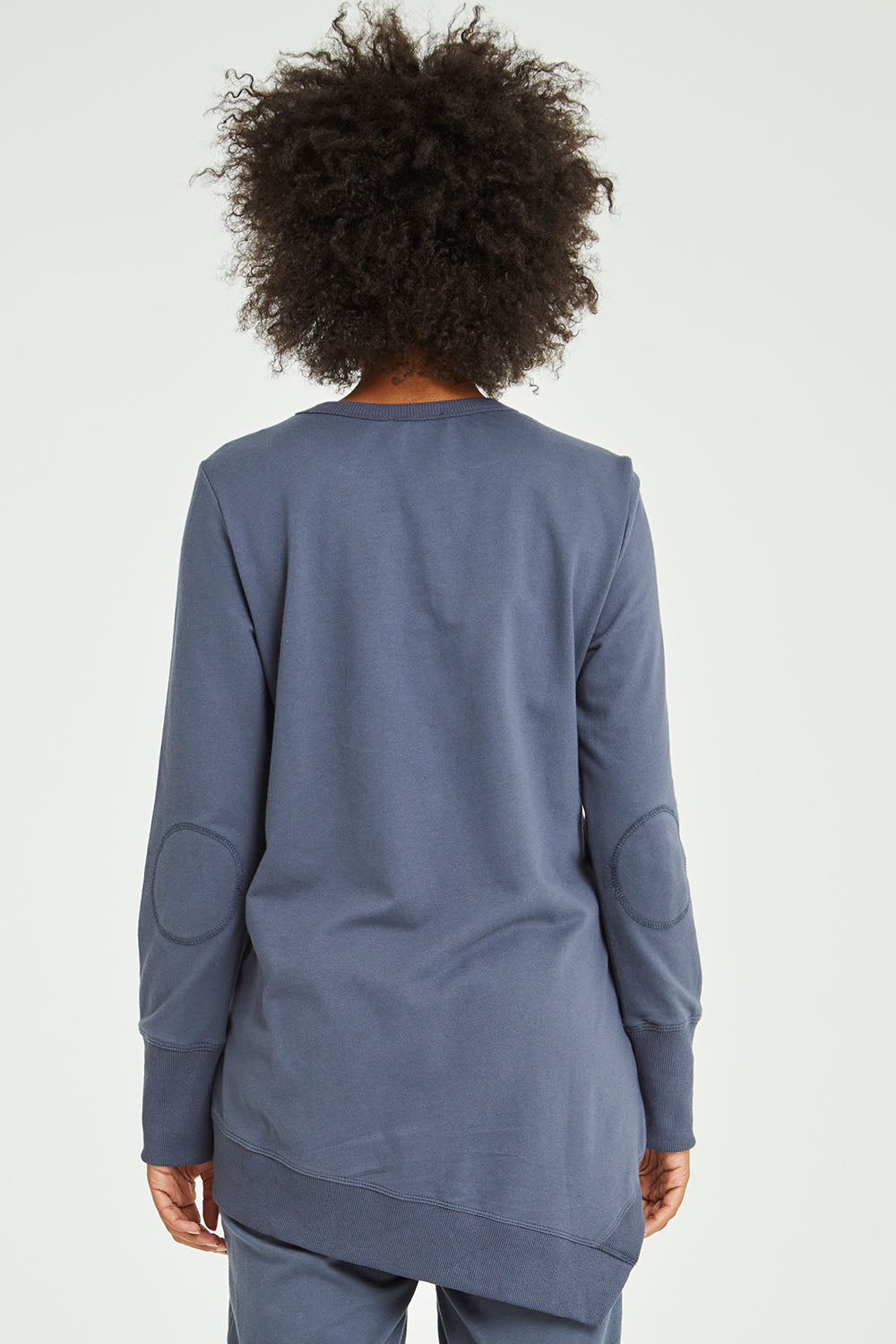 Model Olivia wearing size 10 of the Dolly Sweat in colour Indiblue (Blue), from the back