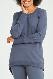 Model Olivia wearing size 10 of the Dolly Sweat in colour Indiblue (Blue), from the front, cropped image