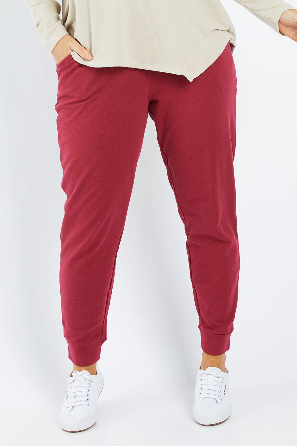 Model Laura wearing size 12 of the Lindsay Jogger in colour Wildberry (Red), from the front, cropped image
