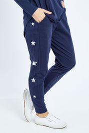 Model Andrea wearing size 10 of the Lindsay Jogger in colour Navystar (Blue), from the front, cropped image