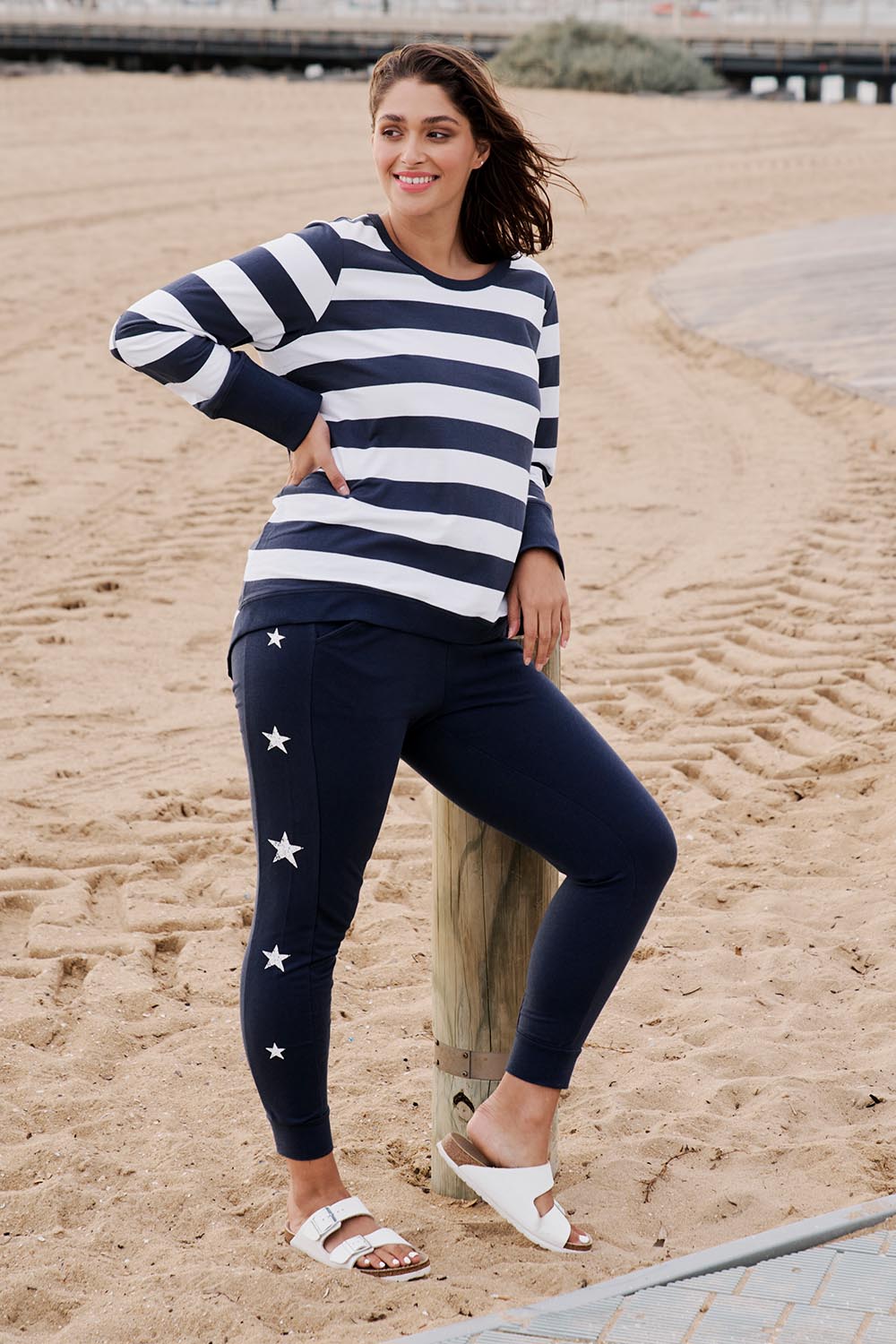 A model wearing the Lindsay Jogger in colour Navystar (Blue), from the front, showing the whole outfit