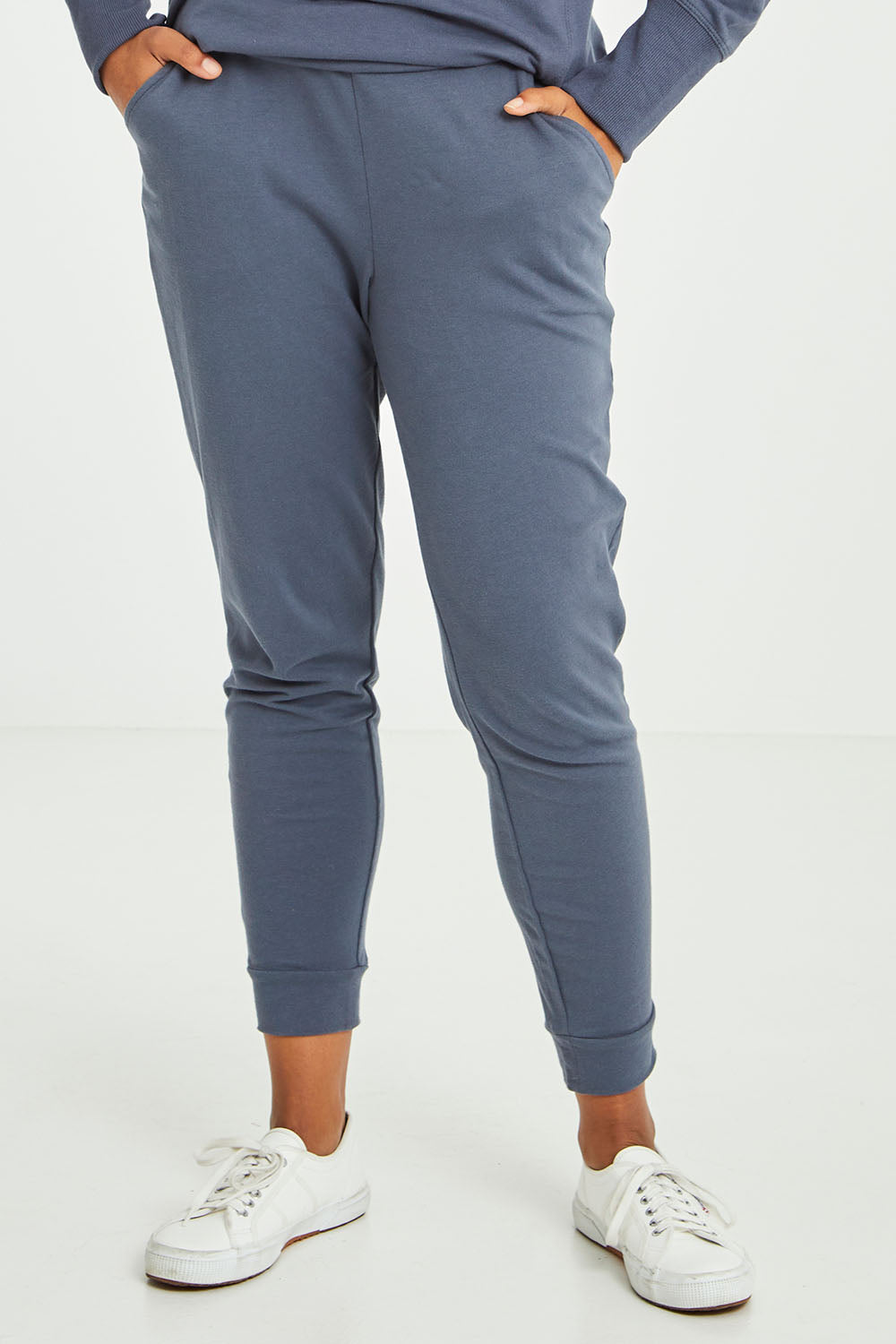 Model Olivia wearing size 10 of the Lindsay Jogger in colour Indiblue (Blue), from the front, cropped image