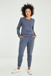 Model Olivia wearing size 10 of the Lindsay Jogger in colour Indiblue (Blue), from the front, showing the whole outfit