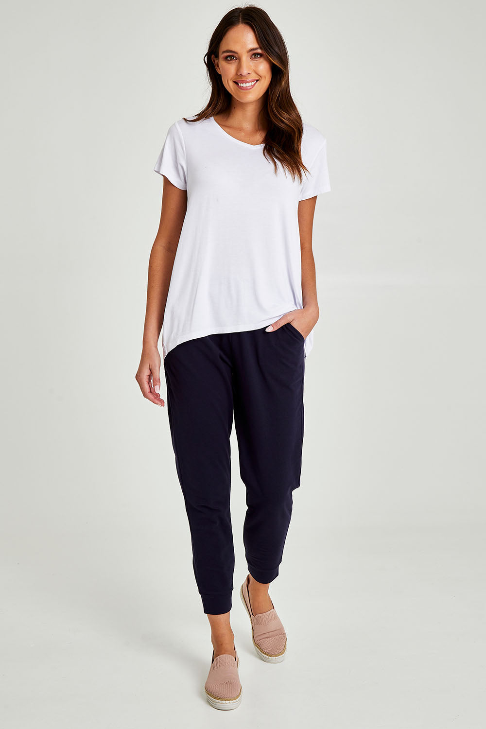 Model Madeline wearing size 10 of the Lindsay Jogger in colour Navy (Blue), from the front, showing the whole outfit