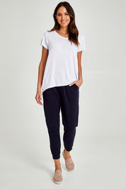 Model Madeline wearing size 10 of the Lindsay Jogger in colour Navy (Blue), from the front, showing the whole outfit