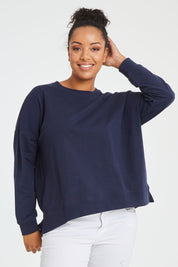 Model Noli wearing size 14 of the Sienna Sweat in colour Navy (Green), from the front, cropped image