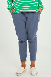 Model Olivia wearing size 10 of the Marissa Jogger in colour Indiblue (Blue), from the front, cropped image