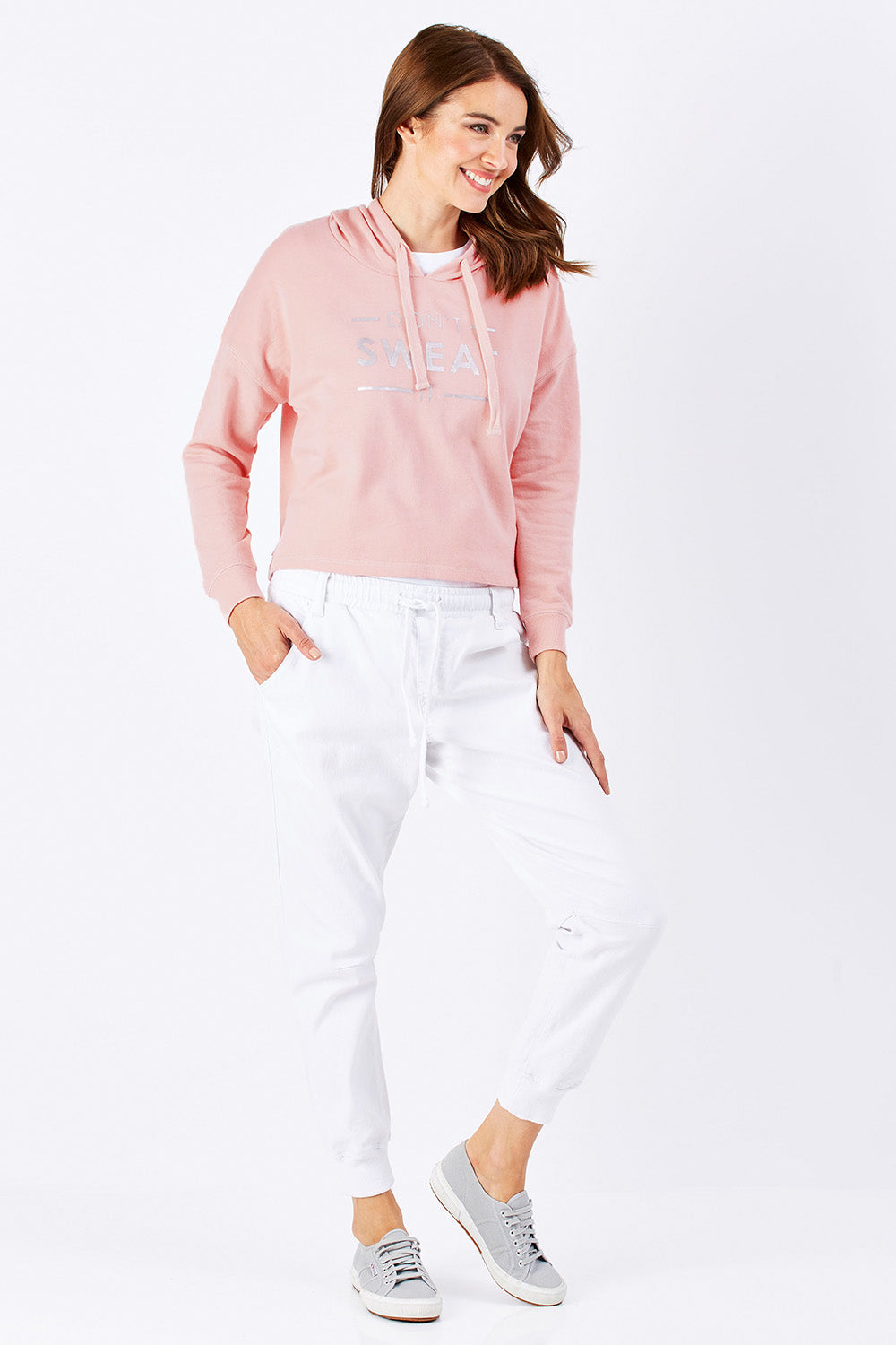 Model Rebecca wearing size 10 of the Oscar Hoodie in colour Blossom (Pink), from the front, showing the whole outfit