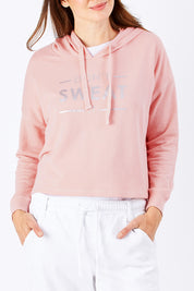 Model Rebecca wearing size 10 of the Oscar Hoodie in colour Blossom (Pink), from the front, showing the whole outfit