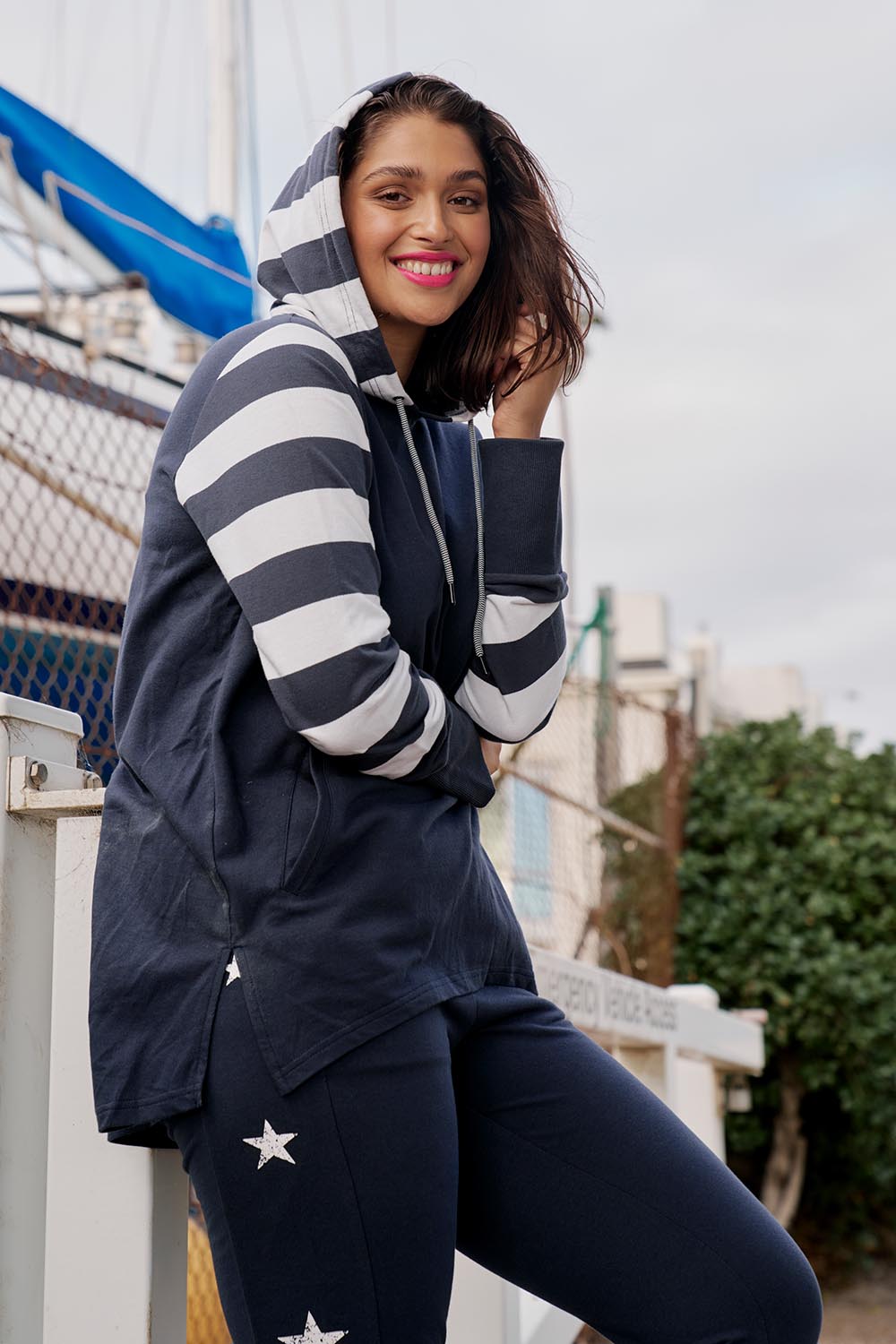 A model wearing the Colbie Hoodie in colour Navymulti (Blue), from the front, showing the whole outfit