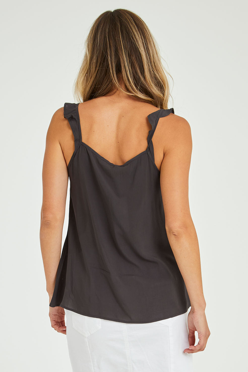 Model Alice wearing size 10 of the Jenna Top in colour Petrol (Black), from the back