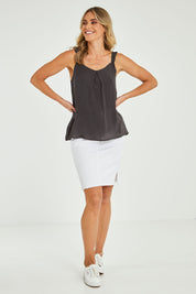 Model Alice wearing size 10 of the Jenna Top in colour Petrol (Black), from the front, showing the whole outfit