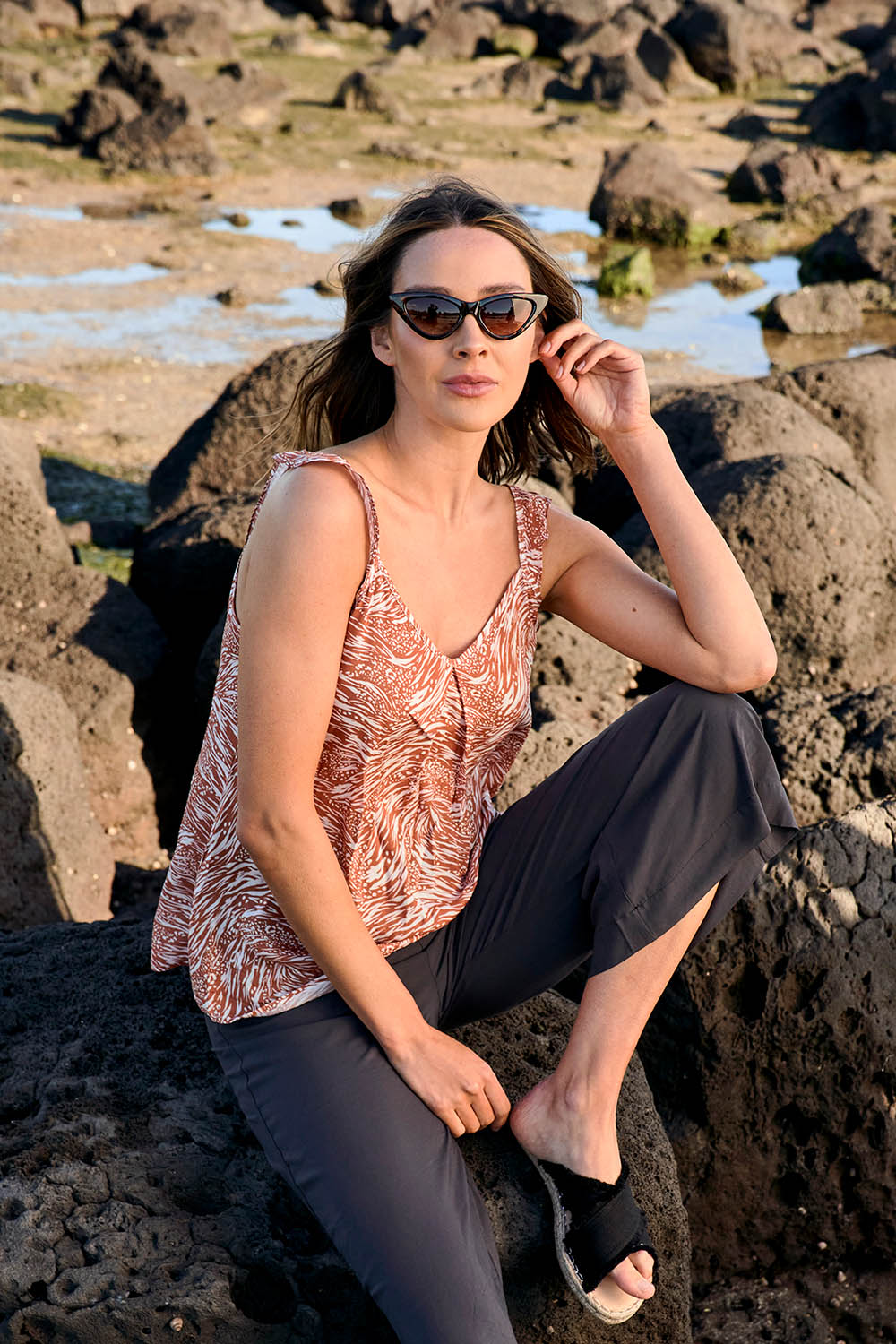 A model wearing the Jenna Top in colour Sarabi, from the front, showing the whole outfit