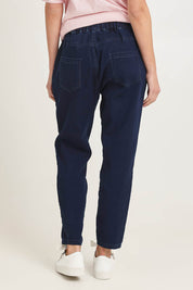 Model Madeline wearing size 10 of the Brooks Jean in colour Darkblue (Blue), from the back
