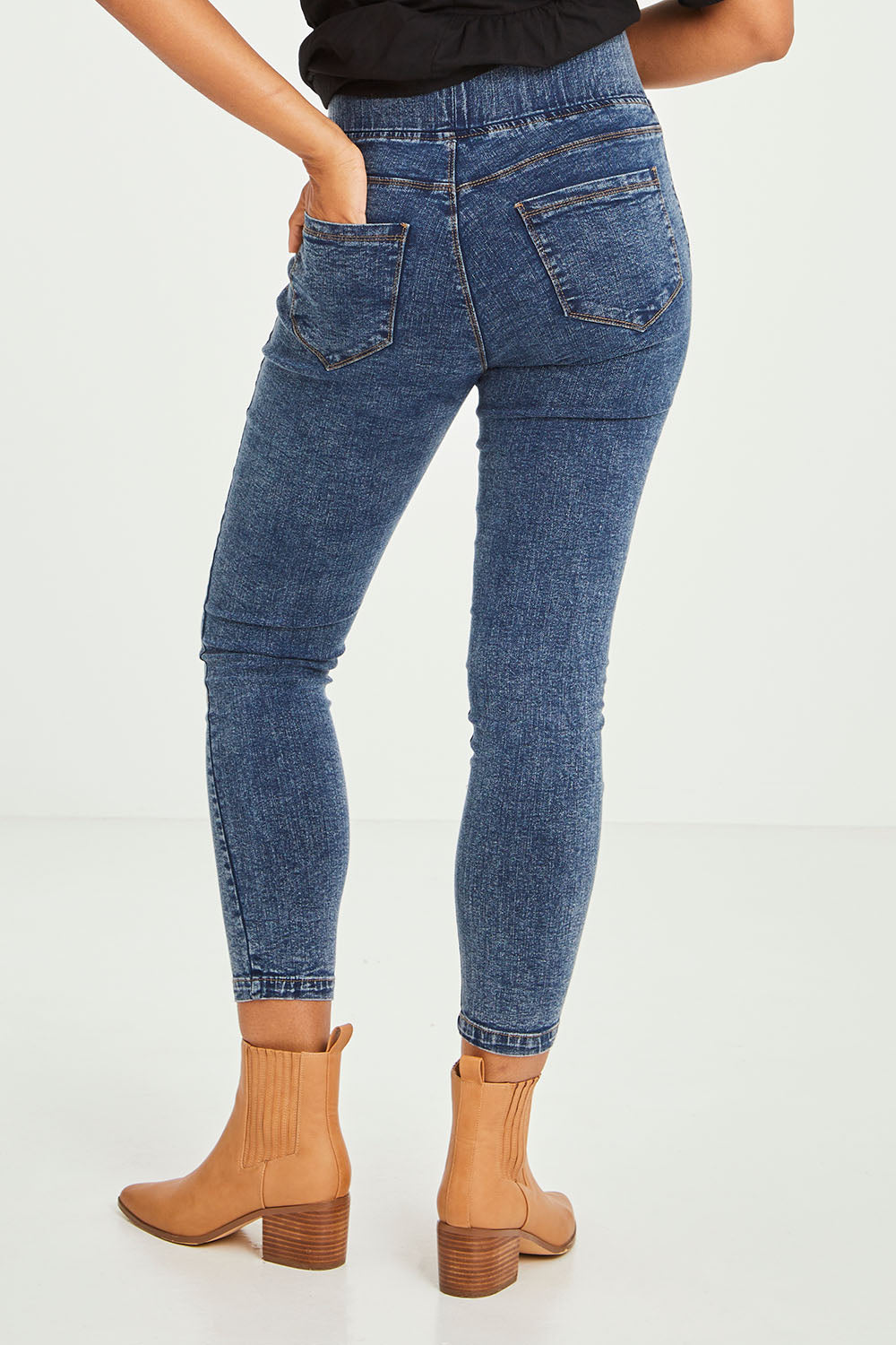 Model Olivia wearing size 10 of the Aiden Stretch Jean in colour Dustyblue (Blue), from the back