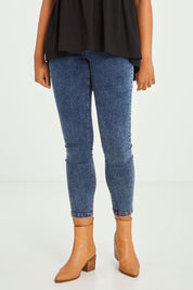 Model Olivia wearing size 10 of the Aiden Stretch Jean in colour Dustyblue (Blue), from the front, cropped image
