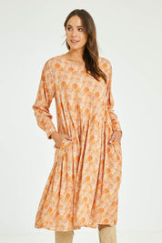 Model Madeline wearing size 10 of the Sharni Dress in colour Bohemian, from the front, cropped image