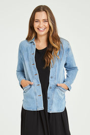 Model Tahlia wearing size 10 of the Reese Denim Shacket in colour Denim (Blue), from the front, cropped image