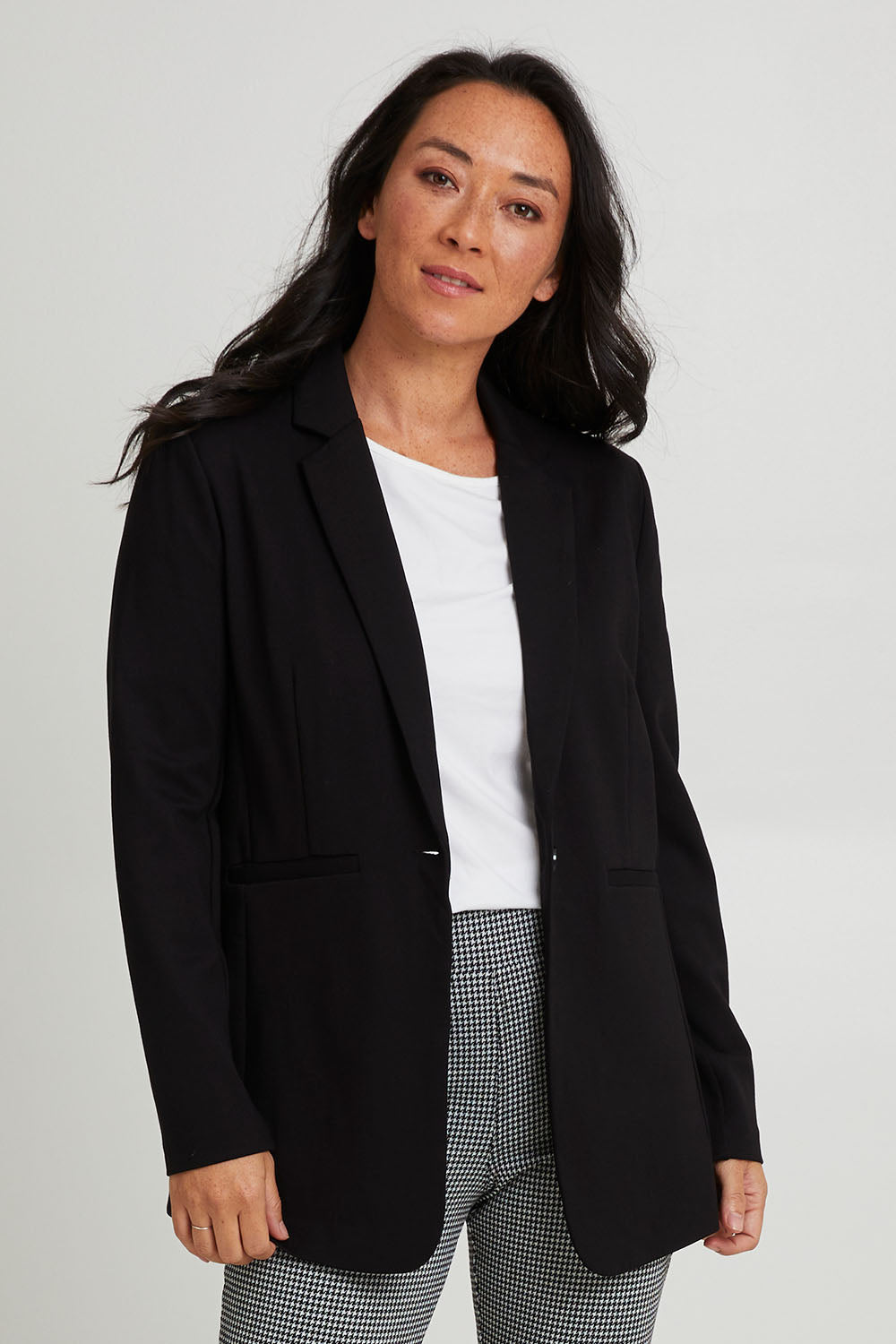 Model Katie wearing size 10 of the Portsea Blazer in colour Black (Black), from the front, cropped image