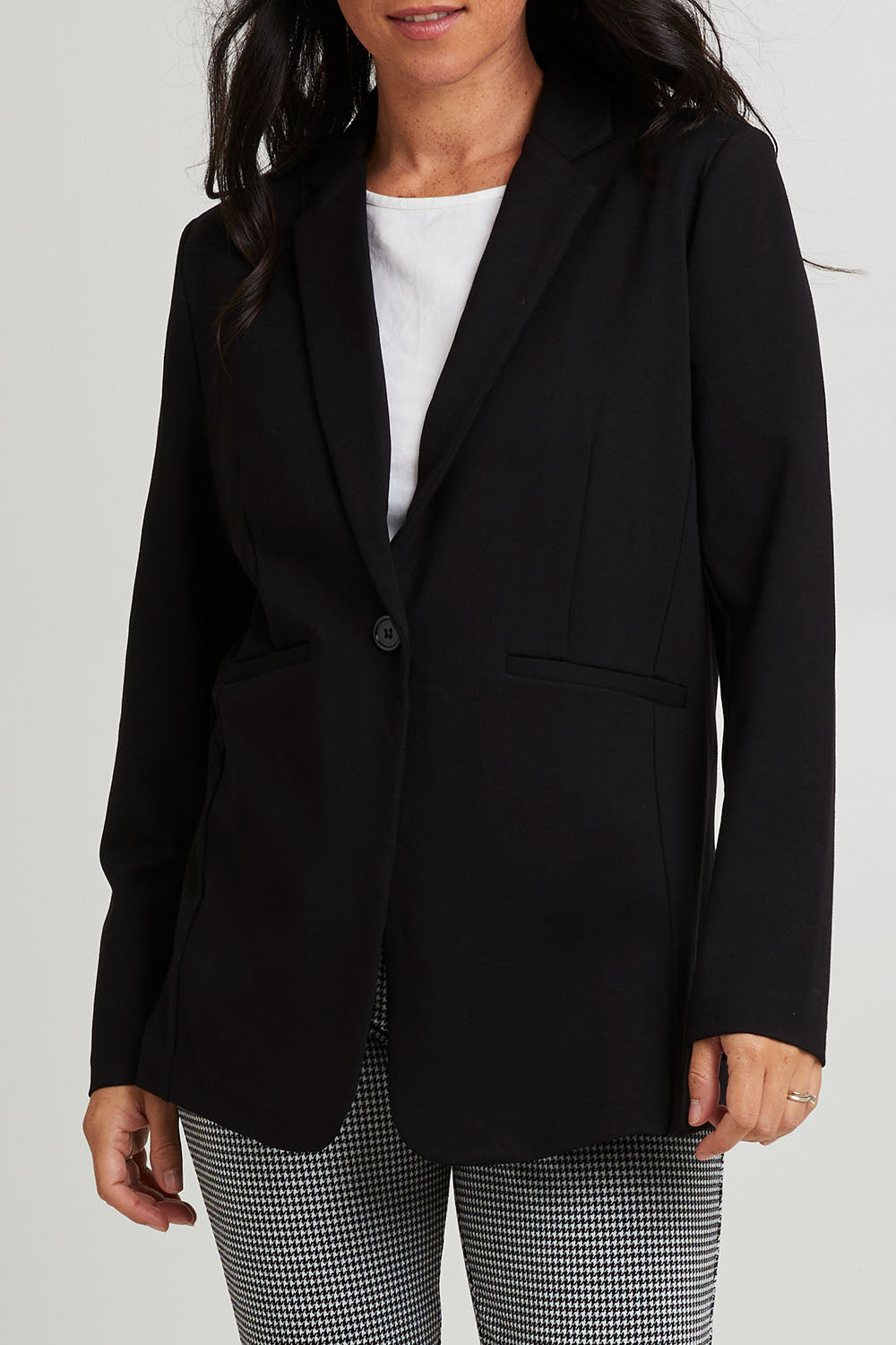 Model Katie wearing size 10 of the Portsea Blazer in colour Black (Black), from the front, cropped image