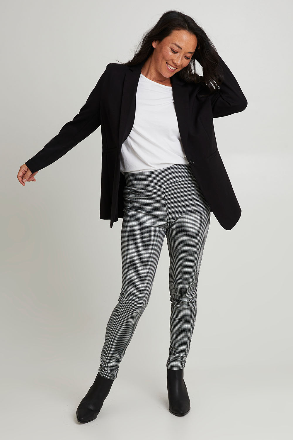 Model Katie wearing size 10 of the Portsea Blazer in colour Black (Black), from the front, showing the whole outfit