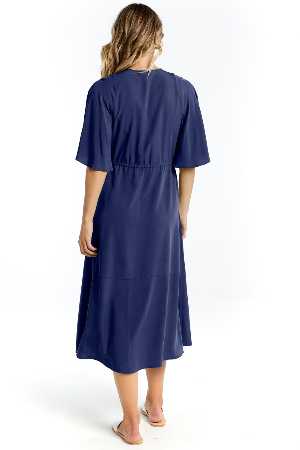 A model wearing the Cora Cotton Dress in colour Frenchblue (Blue), from the back