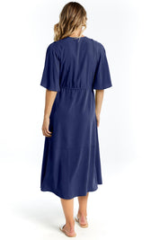 A model wearing the Cora Cotton Dress in colour Frenchblue (Blue), from the back